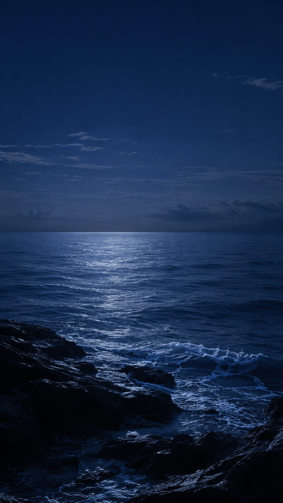 Moonlight reflecting across dark ocean waves at night