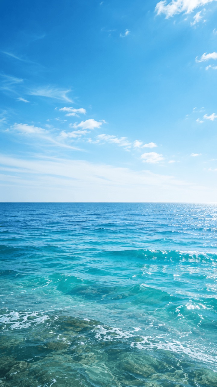 Bright blue ocean waves beneath an open sky
