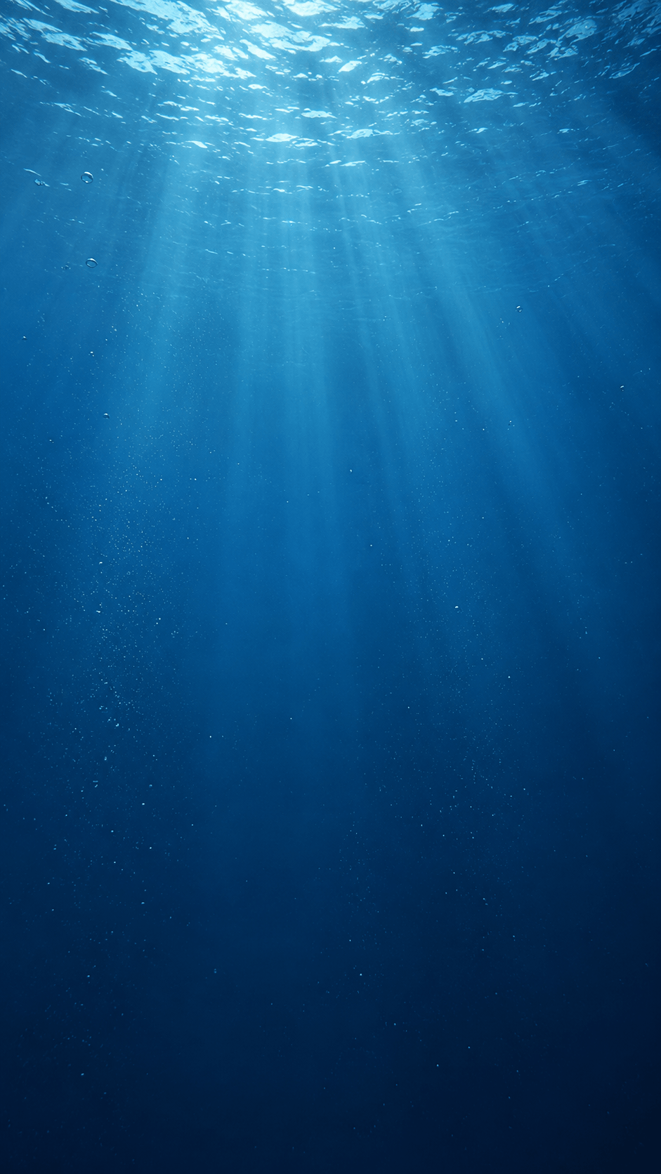 Blue light filtering through deep ocean water